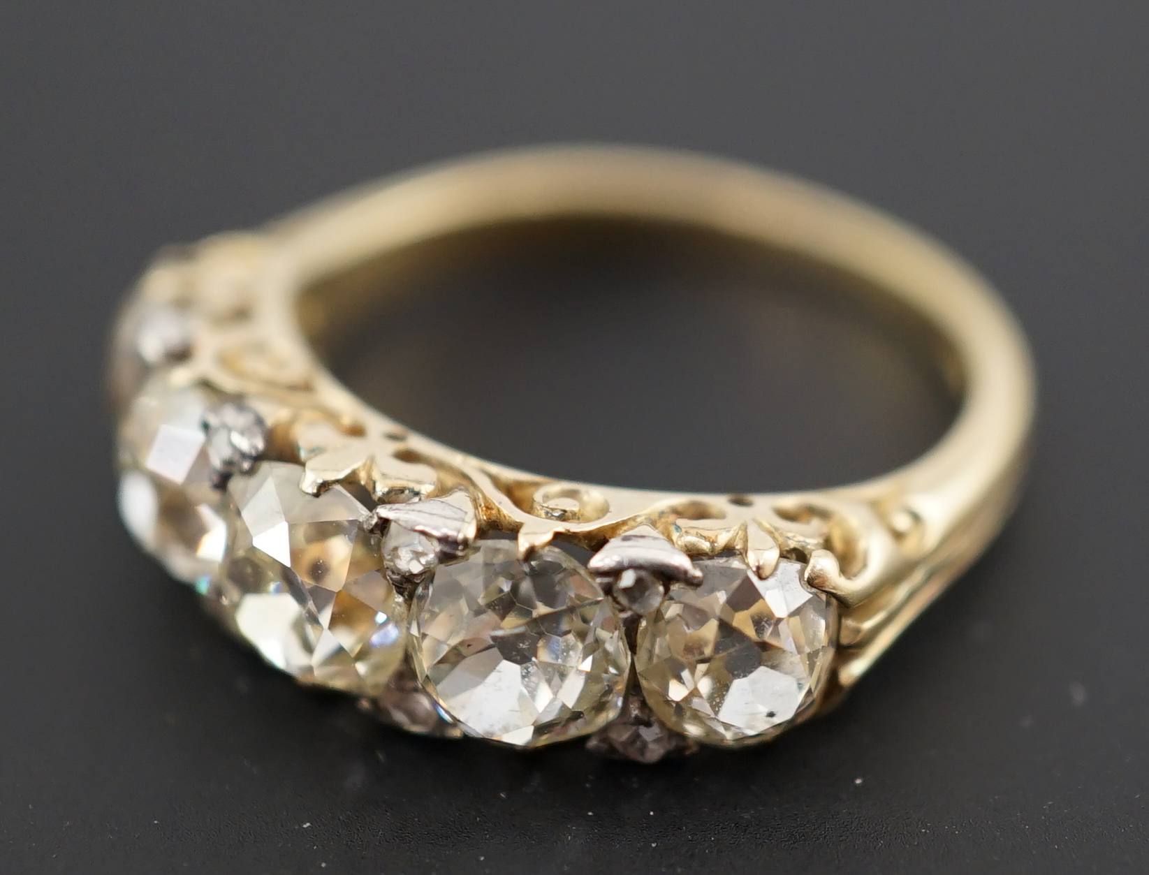 A Victorian 18ct and graduated five stone old round cut diamond set half hoop ring